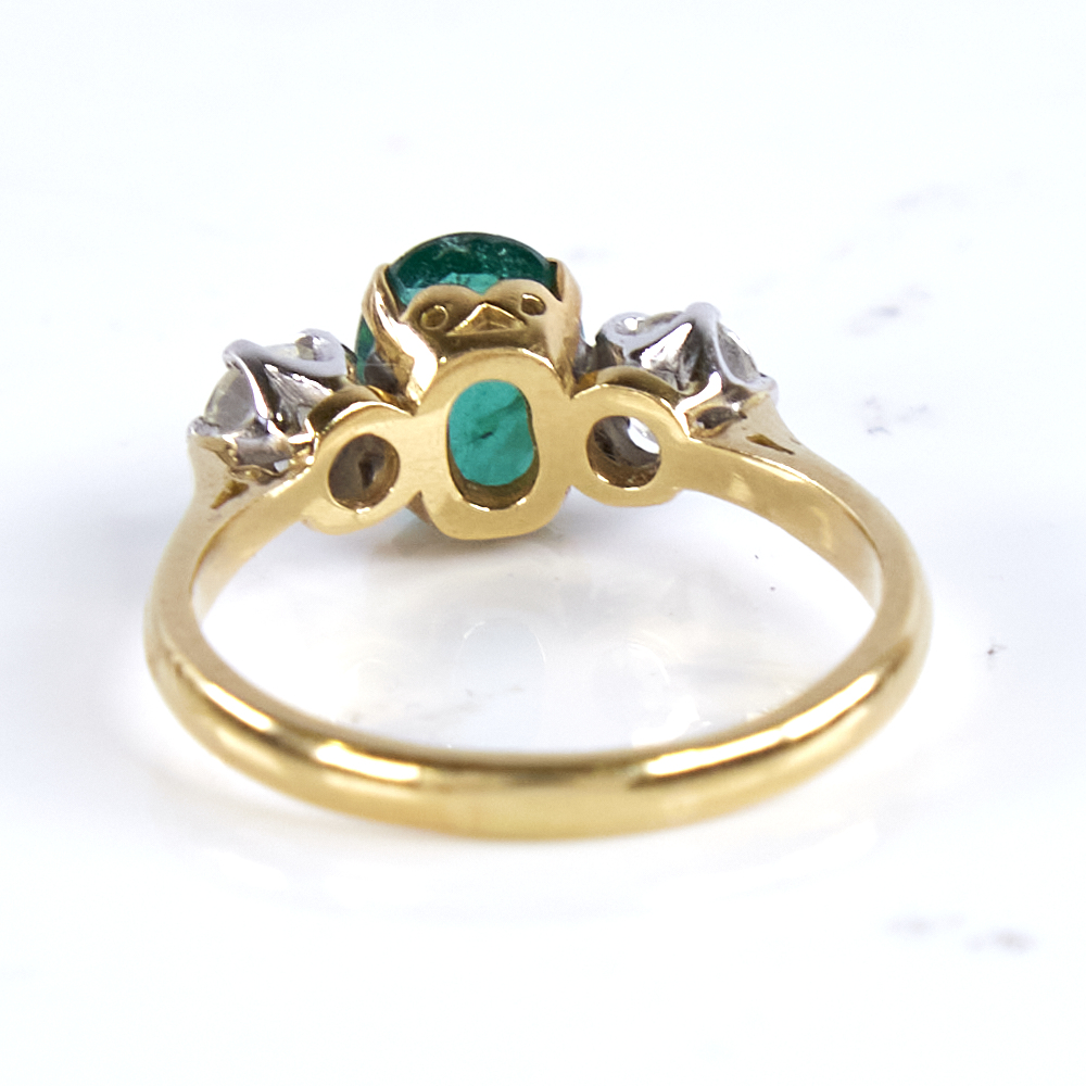 A mid-20th century unmarked high carat gold 3-stone emerald and diamond ring, set with oval mixed- - Image 3 of 5