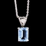 A modern 18ct white gold aquamarine and diamond pendant necklace, set with emerald-cut aqua and