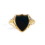 A large 19th century 15ct gold bloodstone shield seal ring, engraved leaf shoulders, hallmarks