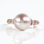 A modern 14ct rose gold pearl and diamond dress ring, set with whole pink South Sea pearl and