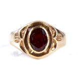 An 18ct gold garnet signet ring, set with oval mixed-cut garnet with decorated shoulders, setting