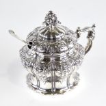 A Victorian silver mustard pot, pumpkin form with relief embossed floral decoration, floral
