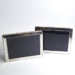 A pair of Elizabeth II silver-fronted rectangular photo frames, with velvet backings and strut