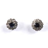 A modern pair of unmarked white gold sapphire and diamond cluster stud earrings, settings test as