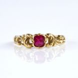 A late 20th century 18ct gold ruby dress ring, set with emerald-cut ruby and pierced foliate