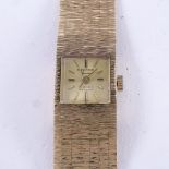 DELVINA - a lady's Vintage 9ct gold mechanical wristwatch, gilt dial with baton hour markers and 9ct