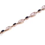 A modern rose gold plated sterling silver morganite and sapphire bracelet, set with alternating