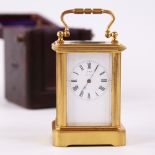 A 19th century miniature brass-cased carriage clock timepiece, white enamel dial with Roman