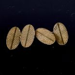 A pair of mid-20th century 9ct gold cufflinks, oval panels with engine turned decoration,