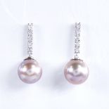 A modern pair of 14ct white gold pink South Sea pearl and diamond line earrings, total diamond