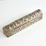 A George V silver dome-top dressing table box, long rectangular form with relief embossed decoration