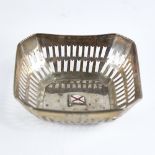 A small George V silver bon bon dish, canted square form with pierced gallery and central