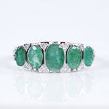 A modern 14ct white gold graduate 5-stone emerald and diamond half hoop ring, set with oval-cut