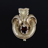 A Victorian unmarked gold garnet motif brooch, set with oval-cut garnet with allover engraved