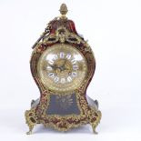 A 19th century French tortoiseshell and brass boulle work 8-day mantel clock, shaped case with glass