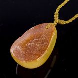 An amber pendant necklace, on cord chain, pendant height 28.6mm, 5.5g Good original condition, there