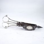 A pair of Georgian silver and steel candle snuffers, with mounted armorial crest, length 16.5cm