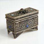 An unmarked silver Judaica miniature casket, floral wirework decoration set with cabochon garnet