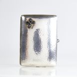 An early 20th century Continental silver curved cigarette case, floral design set with pear-shaped