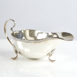 A George V silver sauce boat, gadrooned rim with scrolled acanthus leaf feet, by William Neale & Son