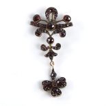 A 19th century Bohemian faceted garnet pendant, unmarked yellow metal settings with hanging 3-leaf