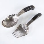 A pair of Middle Eastern unmarked silver horn-handled salad servers, pierced and engraved floral