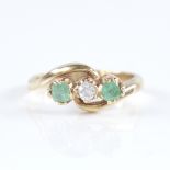 An early 20th century unmarked high carat gold 3-stone emerald and diamond crossover ring, set