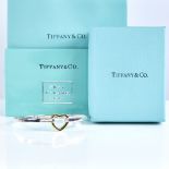 TIFFANY & CO - a modern sterling silver and 18ct gold heart bangle bracelet, heart height 16.3mm,