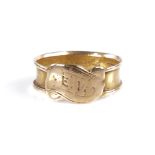 A late 19th century 15ct gold mourning band ring, with central scroll cartouche, vacant hair panel