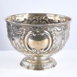 A George V silver pedestal fruity bowl, allover relief embossed foliate and floral decoration, by