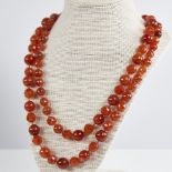 A long Vintage graduated faceted and polished carnelian bead necklace, alternating bead styles,