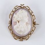 An early 20th century relief carved pink coral cameo brooch/pendant, depicting Classical female