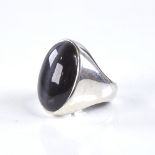 A large modern handmade sterling silver and cabochon cats eye onyx ring, setting height 26.4mm, size