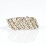 A modern 9ct white gold diamond cluster half hoop ring, set with round and tapered baguette-cut