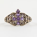 A late 20th century silver-gilt amethyst and diamond cross ring, pierced scrollwork shoulders,