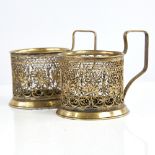 A pair of Russian unmarked gilt white metal tea glass holders, allover filigree wirework decoration,