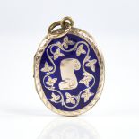 A Victorian unmarked gold and blue enamel locket pendant, engraved scroll and floral decoration,
