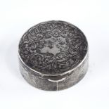 A George V circular silver pillbox, engraved foliate decoration with gilt interior, by Robert