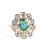 A Continental unmarked gold emerald and diamond cluster flowerhead ring, total diamond content
