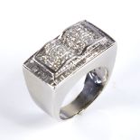 A large modern heavy 18ct white gold diamond cluster ring, pave set with Princess and tapered