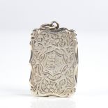 A Victorian silver vinaigrette, scalloped rectangular form with allover engraved floral