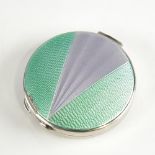 A George V Art Deco silver and enamel circular compact, engine turned green and silver enamel