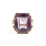 A large late 20th century 9ct gold step-cut amethyst ring, openwork lozenge bridge with raised