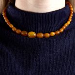 A Vintage single-strand polished butterscotch amber bead necklace, beads ranging from 17.1mm to 7.