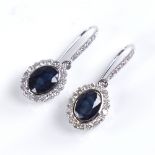 A modern pair of 14ct white gold sapphire and diamond cluster drop earrings, set with oval mixed-cut