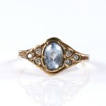 A modern 9ct gold aquamarine and diamond dress ring, set with oval mixed-cut aqua and round