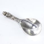 An early 20th century Danish silver presentation ladle, religious figure decorated handle with