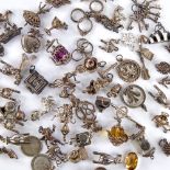 A large quantity of various silver and unmarked charms and fobs, including teapot, animals, cherubs,