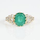 An early 20th century unmarked gold emerald and diamond cluster ring, set with octagonal step-cut