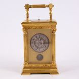 A 19th century gilt-bronze dual time zone repeating carriage clock timepiece, silvered dial with